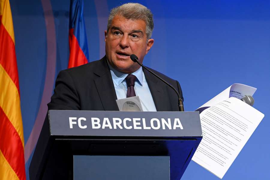 Barcelona president Joan Laporta presents documents as he addresses a press conference at the Camp Nou