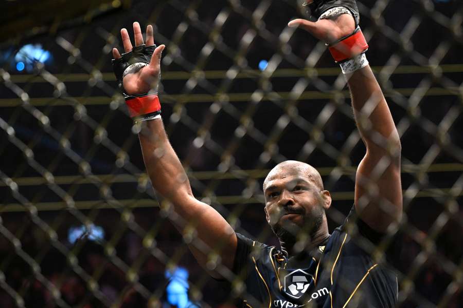 Jon Jones celebrates after defeating French mixed martial arts fighter Ciryl Gane during their UFC 285 title bout
