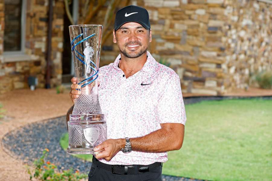 Jason Day of Australia poses for photos with the trophy