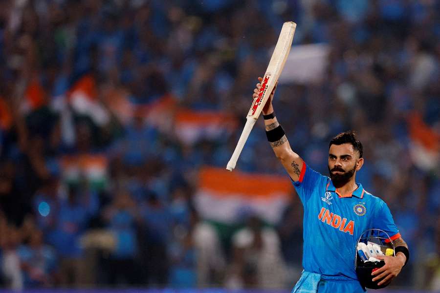 Kohli lifts his bat after reaching his ton