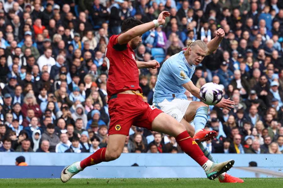 Manchester City's Norwegian striker #09 Erling Haaland (R) shoots to score his fourth goal 