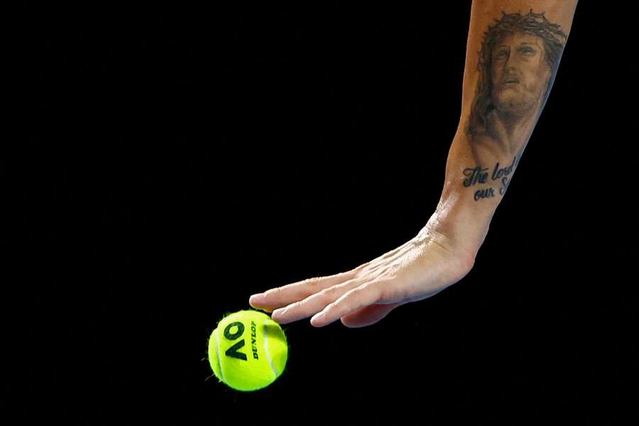 A tattoo on the arm of Britain's Dan Evans is pictured during his Australian Open match against Italy's Lorenzo Sonego
