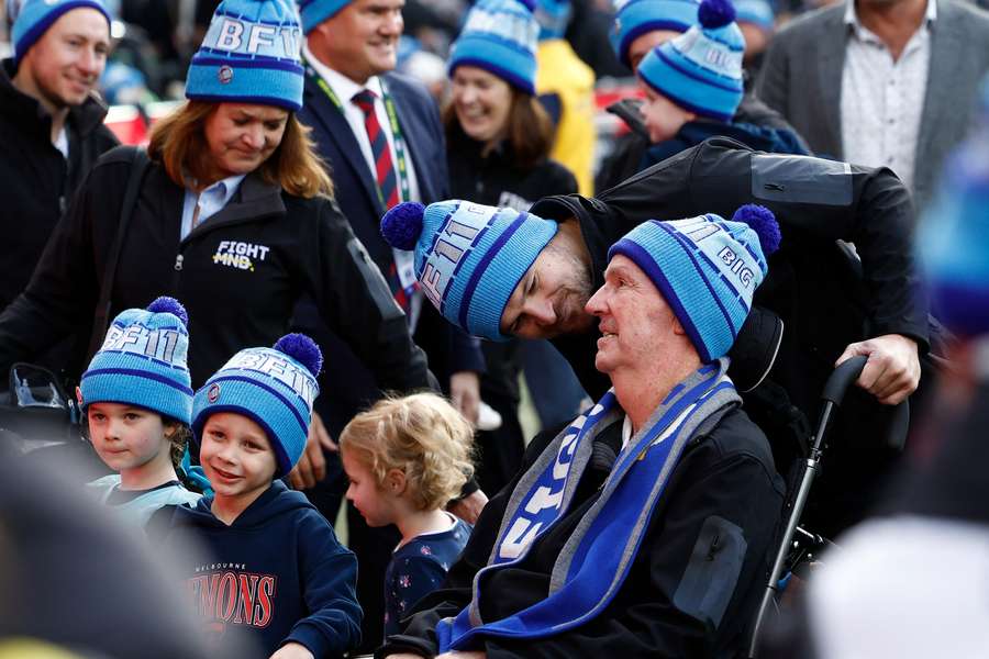 Neale Daniher is surrounded by family during the 2025 'Big Freeze' event at the MCG.