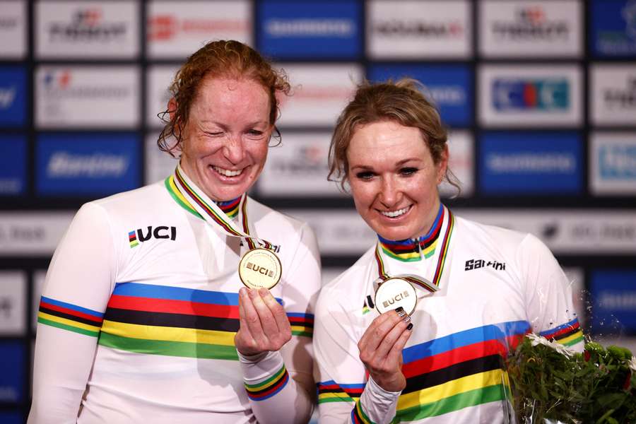 Netherlands' Amy Pieters and Kirsten Wild celebrate with their gold medals on the podium after winning the Women's Madison final