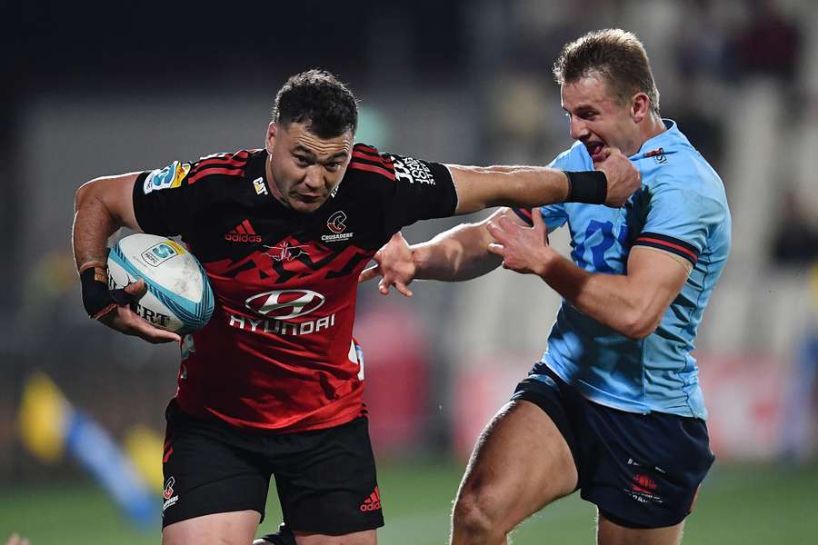 David Havili (L) charges with the ball