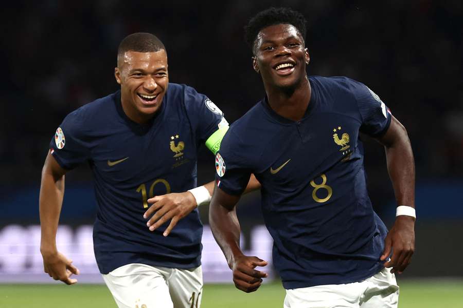 Aurelien Tchouameni celebrates with Kylian Mbappe after scoring France's first goal