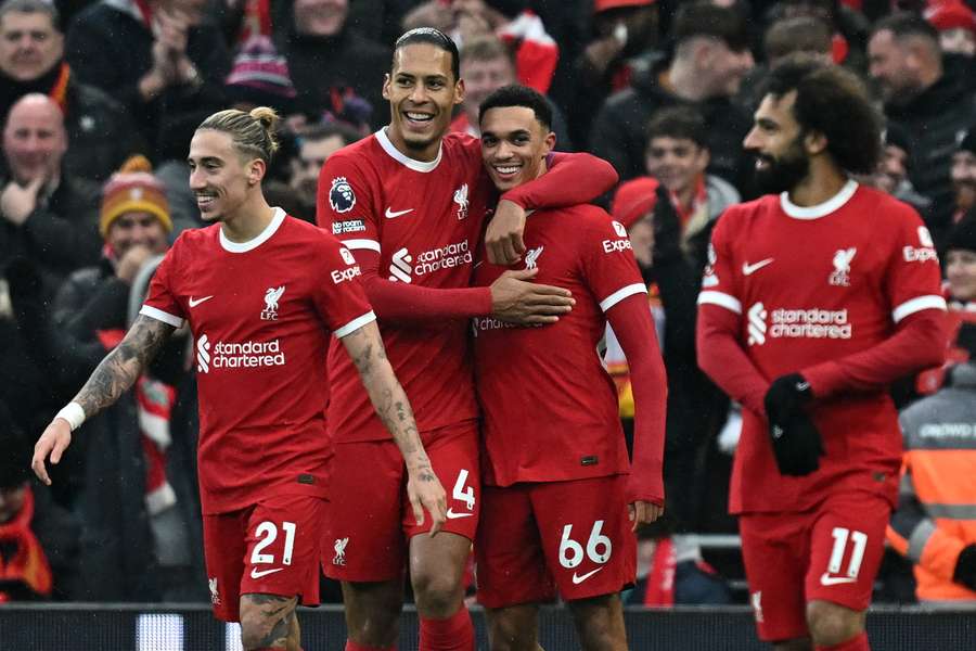 Liverpool's English defender #66 Trent Alexander-Arnold (2R) celebrates with teammates after scoring the opening goal
