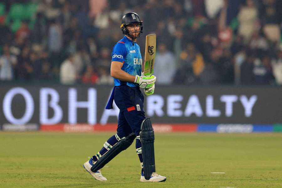 England's Jos Buttler walks off after being caught by Afghanistan's Rahmat Shah off the bowling of Azmatullah Omarzai during the Champions Trophy