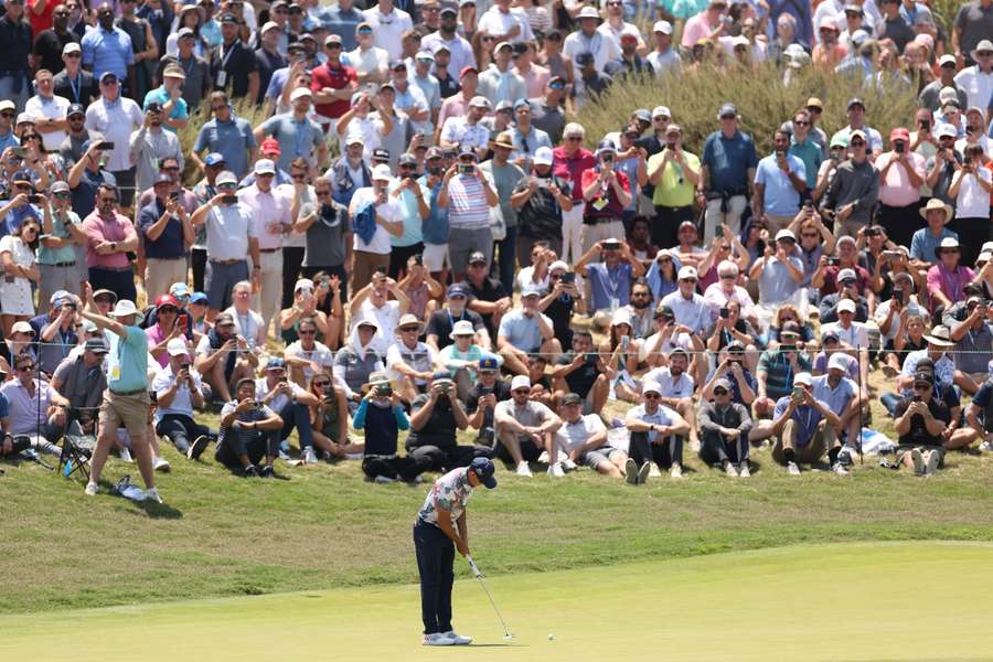 Rickie Fowler of the United States putts on the second green