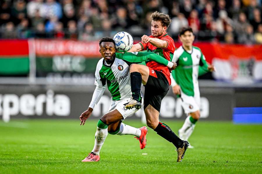 Antoni Milambo (L) en Dirk Proper gaan het duel aan tijdens NEC-Feyenoord.