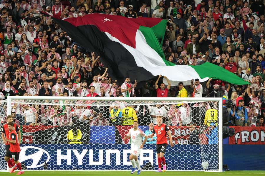 Fans hold Jordan flag in World Cup match against Austria Fans hold Jordan flag in World Cup match against Austria