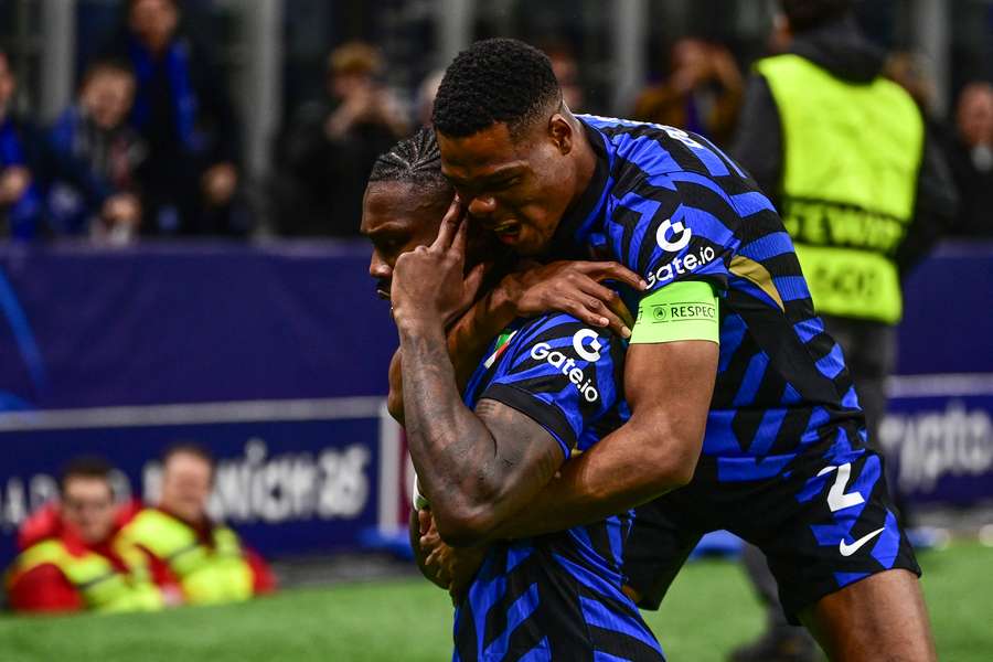 Inter's Marcus Thuram celebrates his 1-0 with captain Denzel Dumfries