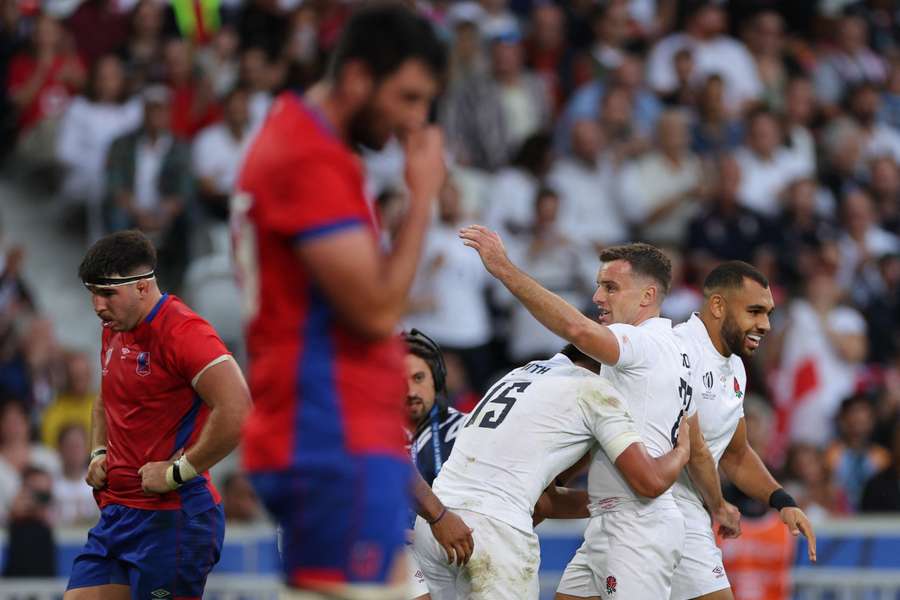 England full-back Marcus Smith (C) celebrates after scoring a try with fly-half George Ford (2R) and centre Joe Marchant (R)