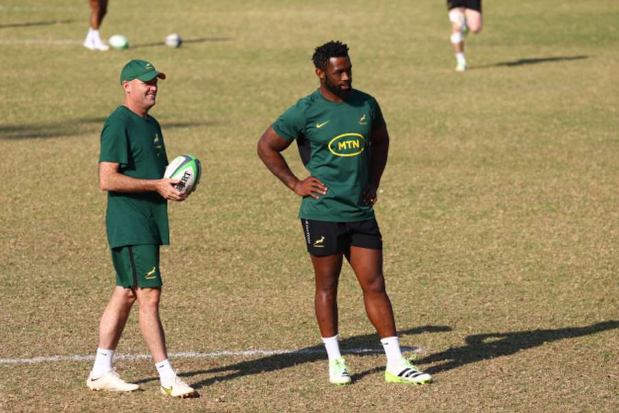 South Africa coach Jacques Nienaber (L) and captain Siya Kolisi during training