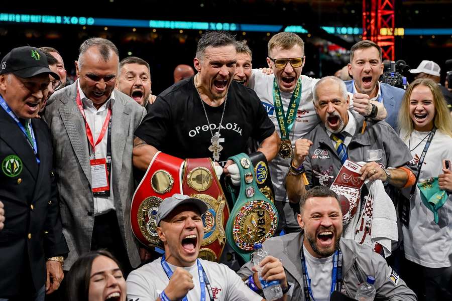 Usyk celebrates with his team after the fight