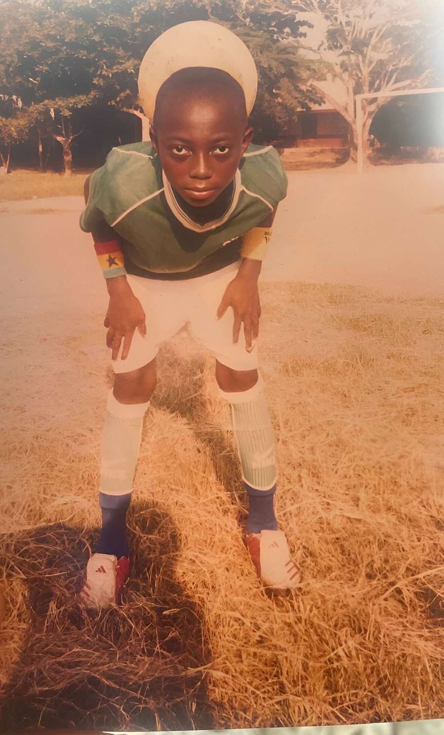 A young Gideon Mensah posing for a picture taken by his father that went viral in his town