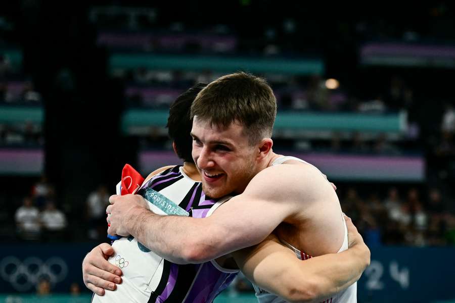 Gold medallist Philippines' Carlos Edriel Yulo is congratulated by bronze medallist Britain's Harry Hepworth 