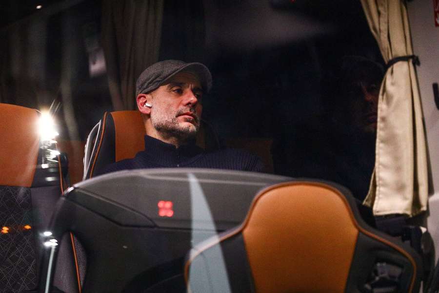 Manchester City manager Pep Guardiola looks dejected on the team bus after the match
