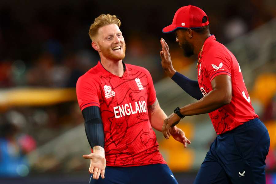 England's Ben Stokes (L) celebrates the wicket of New Zealand's Glenn Phillips with Chris Jordan