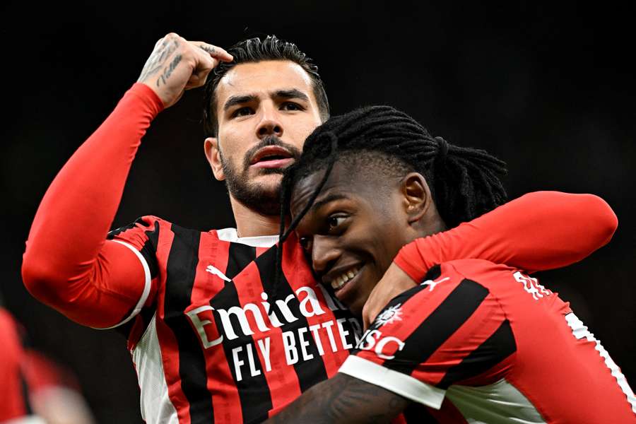 Theo Hernandez celebrates with AC Milan's Rafael Leao (right) after scoring the opening goal