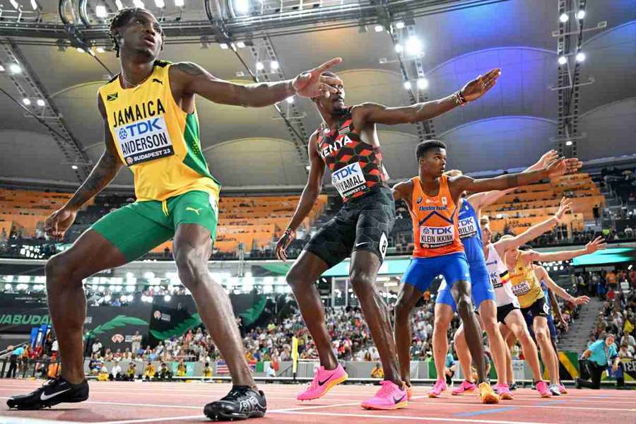 Jamaica's D'Andre Anderson, Kenya's Wyclife Kinyamal and Netherlands' Isaya Klein Ikkink wait to receive their batons Jamaica's D'Andre Anderson, Kenya's Wyclife Kinyamal and Netherlands' Isaya Klein Ikkink wait to receive their batons