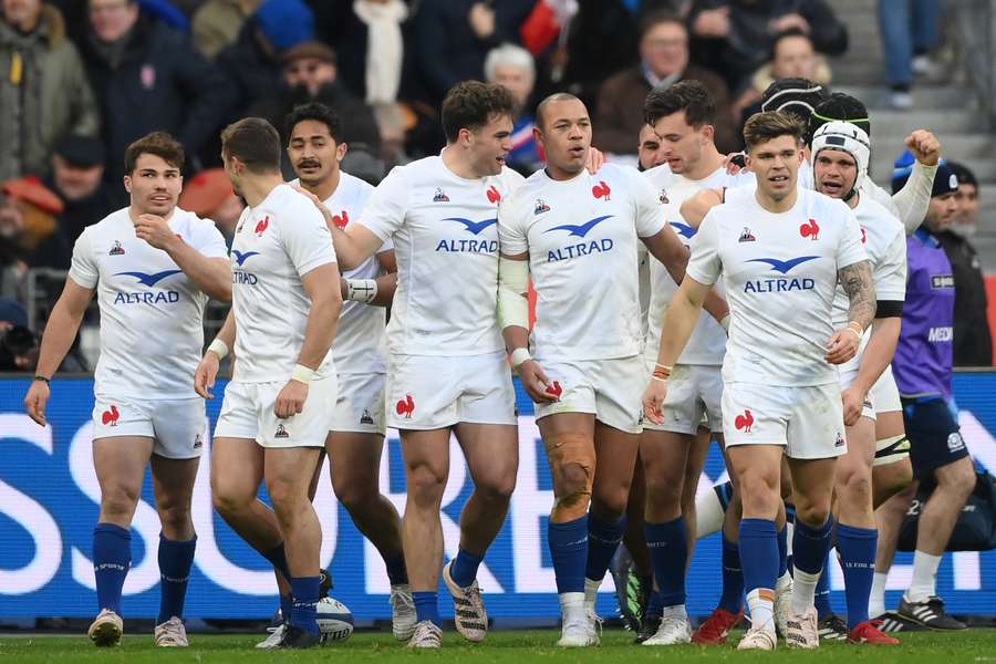 France's centre Gael Fickou (C) celebrates with teammates after scoring a try