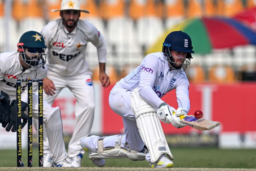 England's Ben Duckett (R) plays a shot