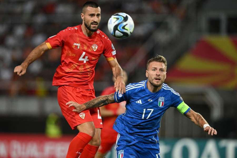 Gjoko Zajkov challenges with Ciro Immobile for the ball