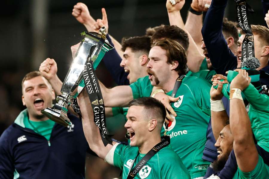Ireland's Johnny Sexton and teammates celebrate with the trophies after winning the Six Nations Championship and the Grand Slam