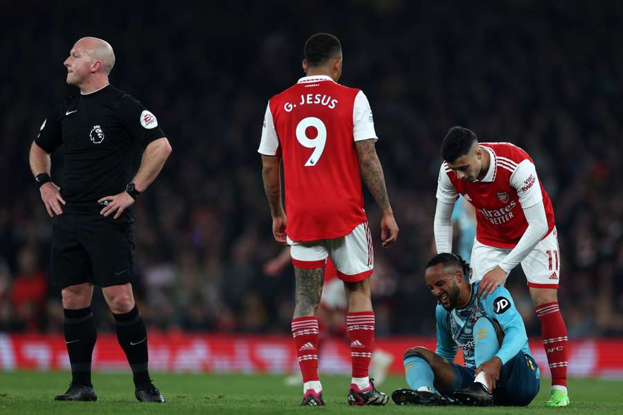 Southampton's English midfielder Theo Walcott is helped by Arsenal's Brazilian midfielder Gabriel Martinelli after picking up an injury