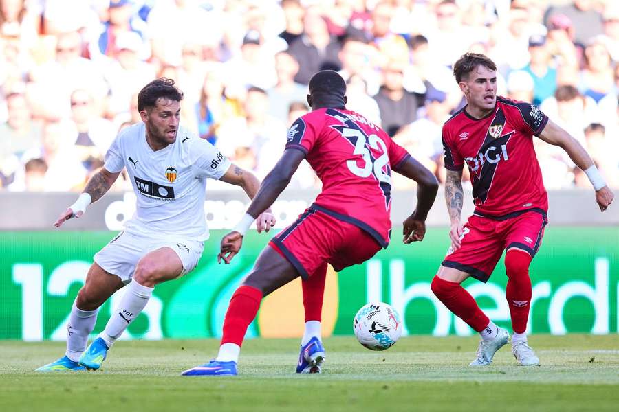 Hugo Duro of Valencia competes for the ball with Pep Chavarria of Rayo Vallecano