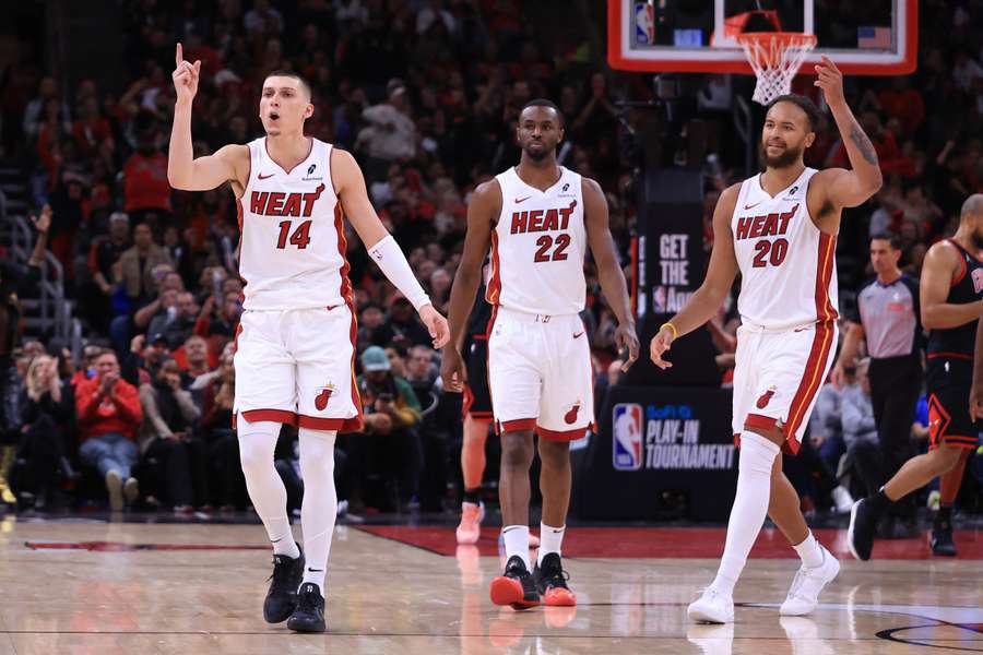 Tyler Herro, Andrew Wiggins and Kyle Anderson of the Miami Heat react against the Chicago Bulls