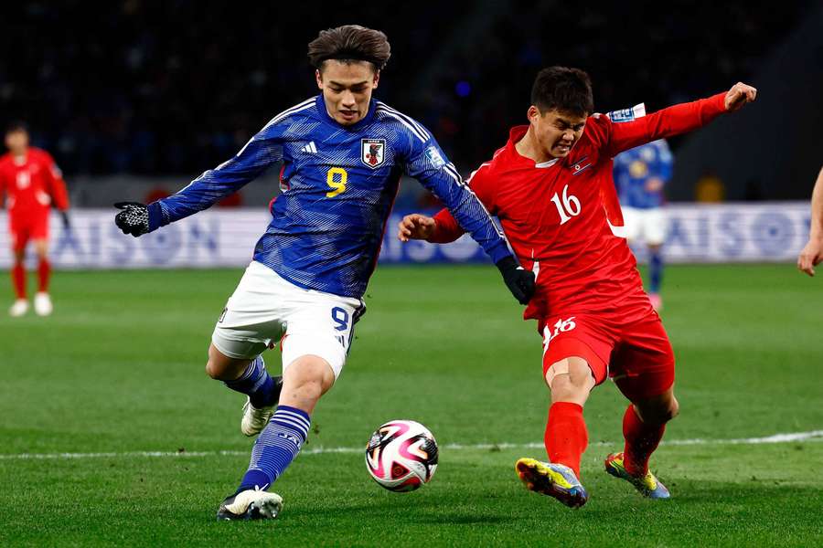 Ueda in action with North Korea's Yu-Song Kim 