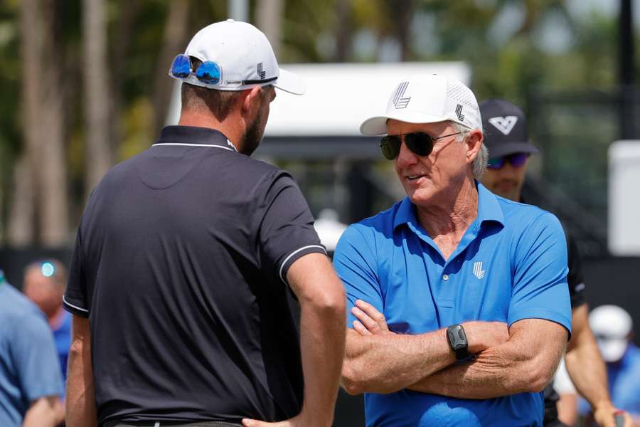 Greg Norman, right, meets with Marc Leishman of the Ripper golf club before the final round of LIV Golf Miami golf tournament 