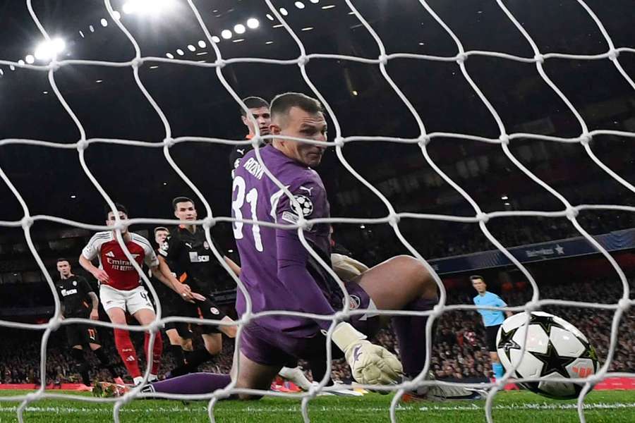 Shakhtar Donetsk goalkeeper Dmytro Riznyk looks on as the ball crosses over the line to give Arsenal the lead