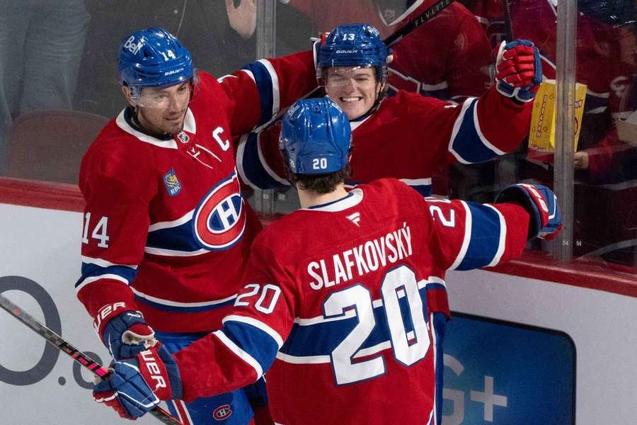 Cole Caufield (middle) celebrates with his teammates after game-winning goal against Bruins