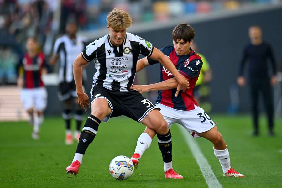 Udinese's Thomas Thiesson Kristensen (left) attempts to shield the ball from Benjamin Dominguez