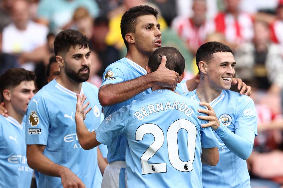 Manchester City midfielder Rodri (C) celebrates his go-ahead goal