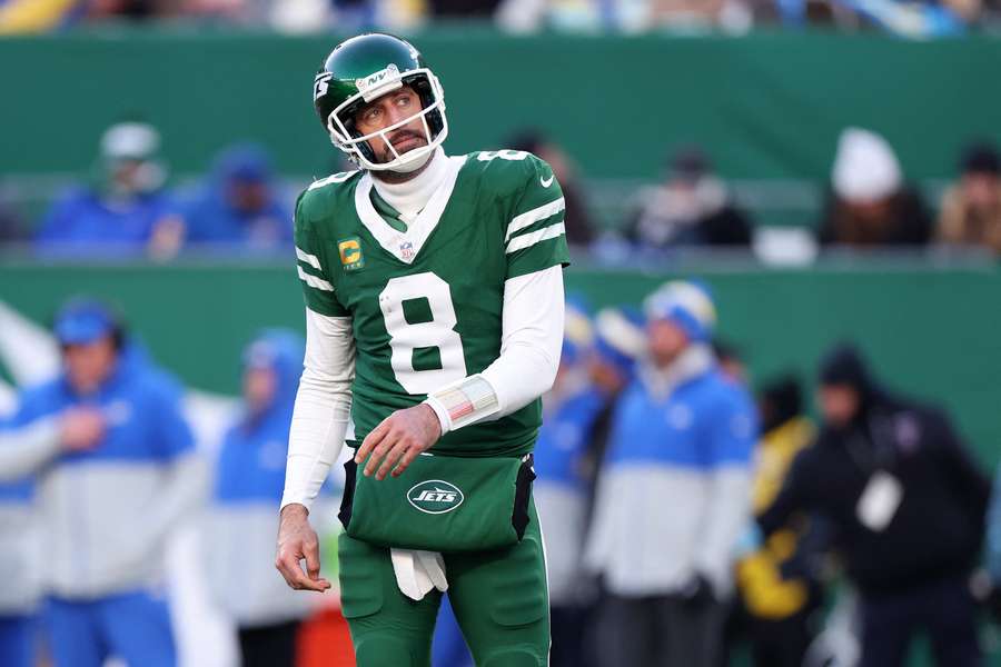 Jets quarterback Aaron Rodgers reacting to a lost fumble