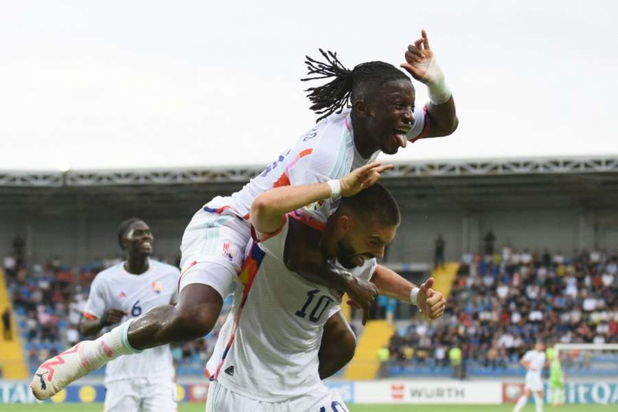 Yannick Carrasco is mobbed after scoring the only goal of the game