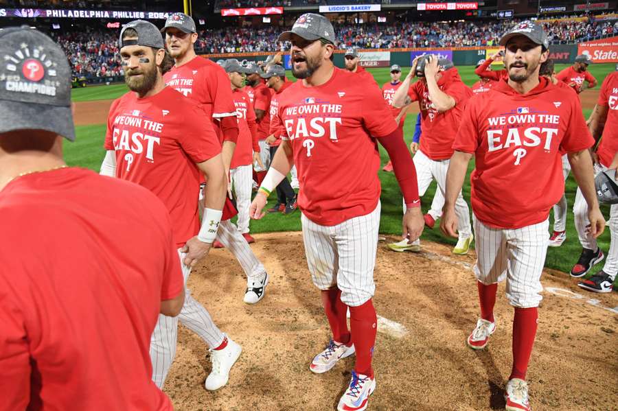 Philadelphia Phillies players celebrate winning the National League East Division with a win against the Chicago Cubs