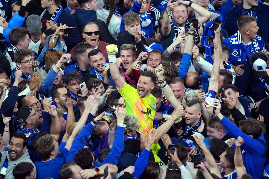 Hamburg goalkeeper Daniel Heuer Fernandes is mobbed by supporters at full-time