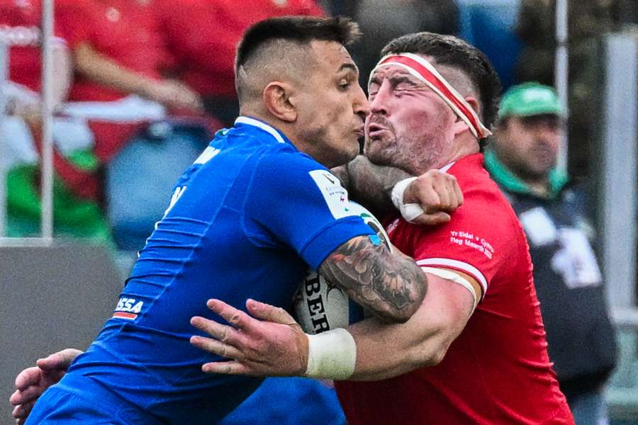 Italy's wing Pierre Bruno (L) elbows Wales' prop Wyn Jones