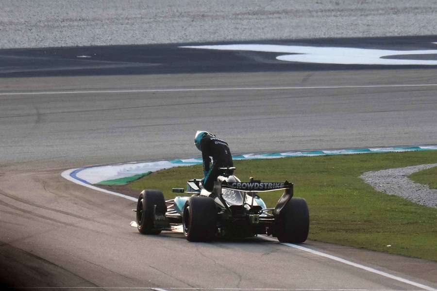 George Russell climbs out of his stricken Mercedes