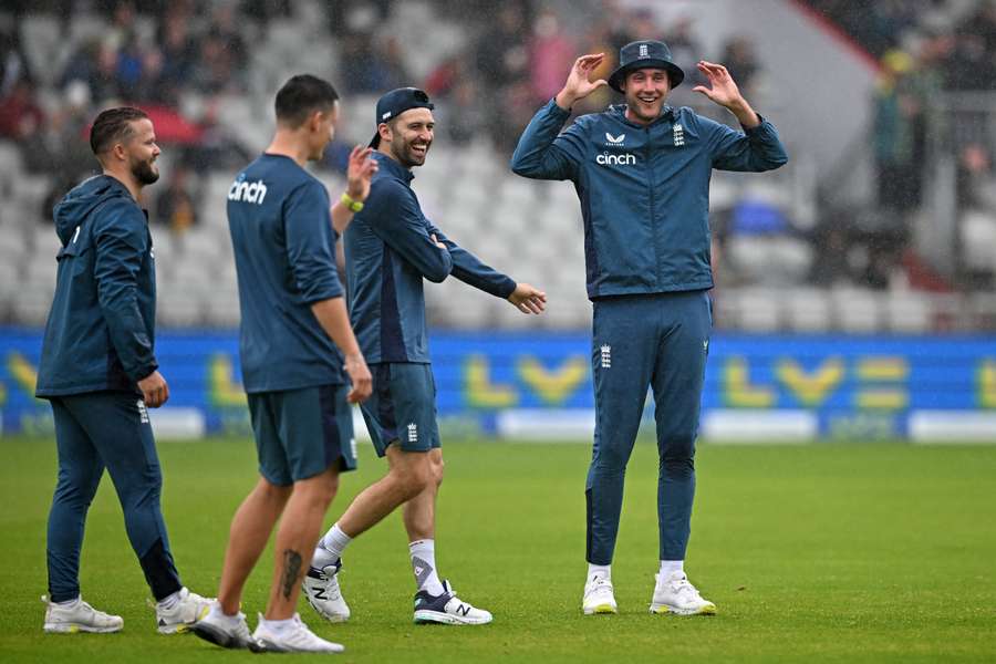 The England players stand in the rain