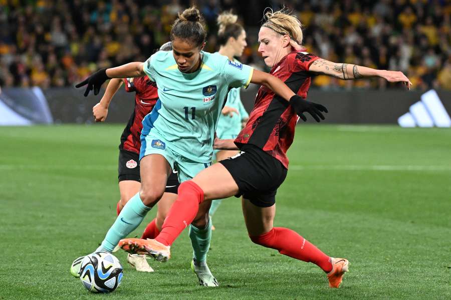 Australia's Mary Fowler and Canada's Sophie Schmidt battle for the ball