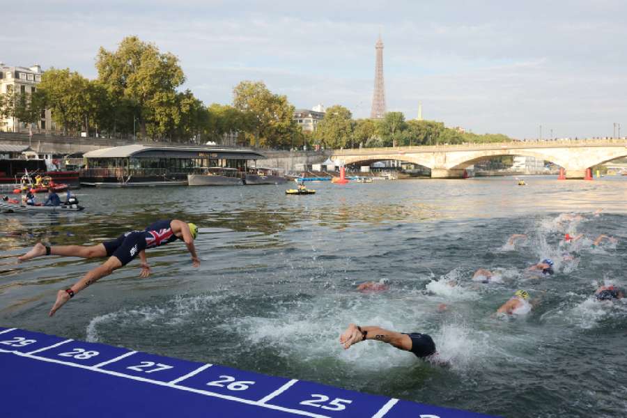 Athletes compete in the elite men's triathlon test event in the Seine 