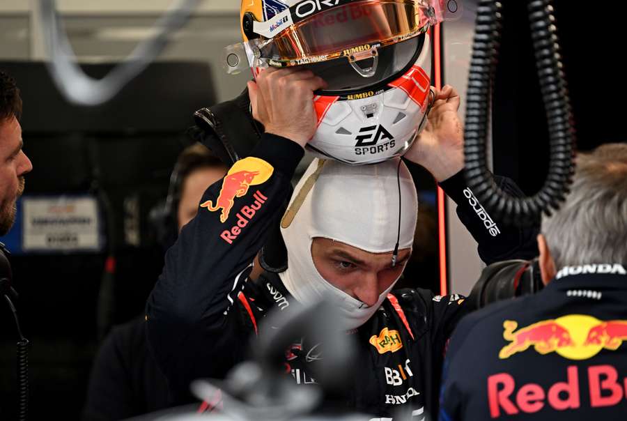 Max Verstappen puts on his helmet ahead of the second practice