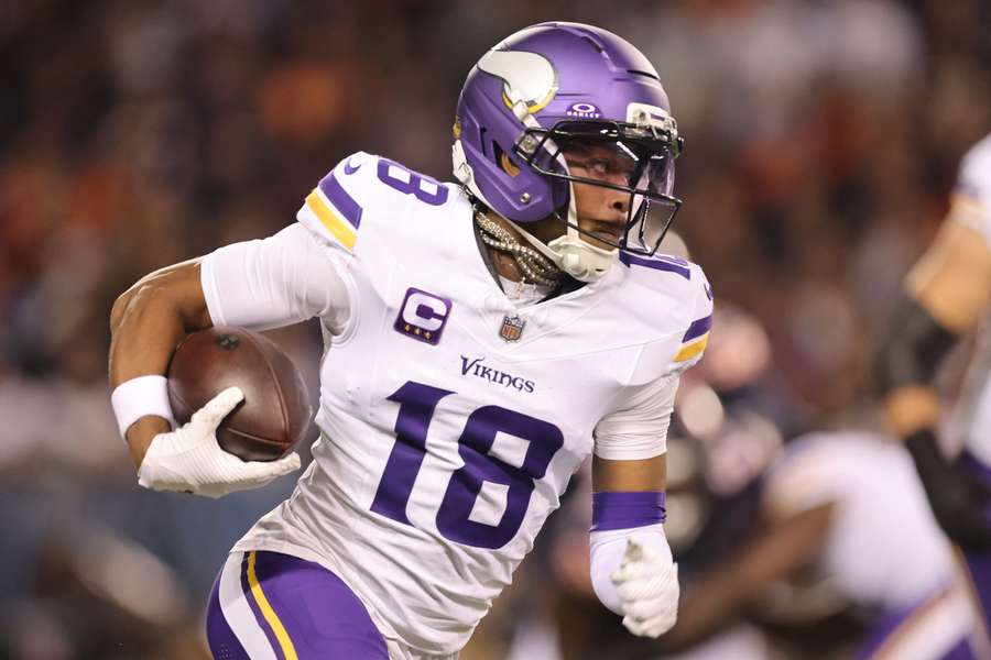Vikings wide receiver Justin Jefferson runs with the ball