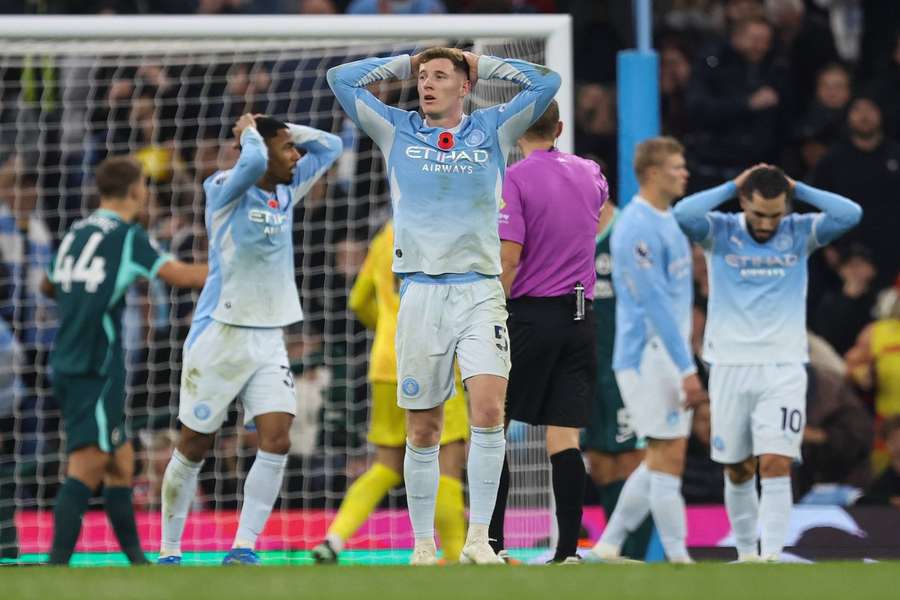Manchester City players react after a missed chance